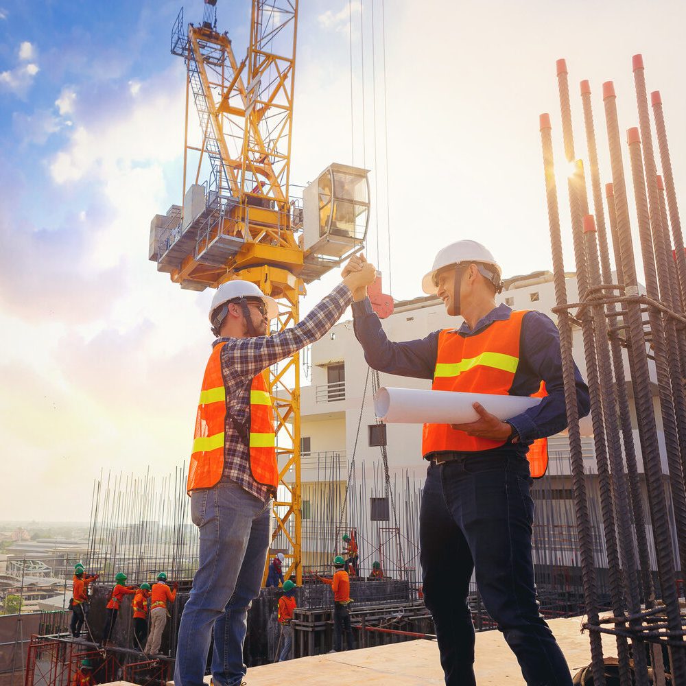 Architect,And,Engineer,Construction,Workers,Shaking,Hands,While,Working,At Architect,And,Engineer,Construction,Workers,Shaking,Hands,While,Working,At