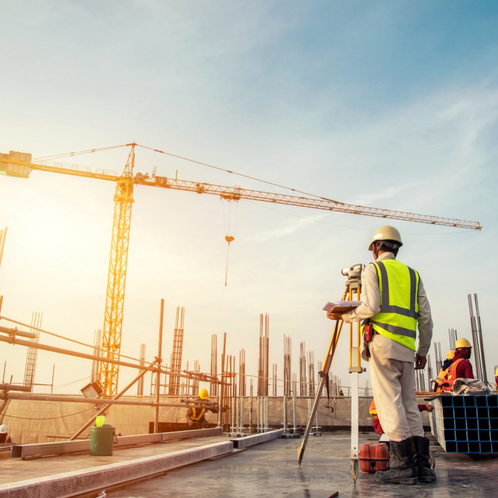 Surveyor,Builder,Engineer,With,Theodolite,Transit,Equipment,At,Construction,Site