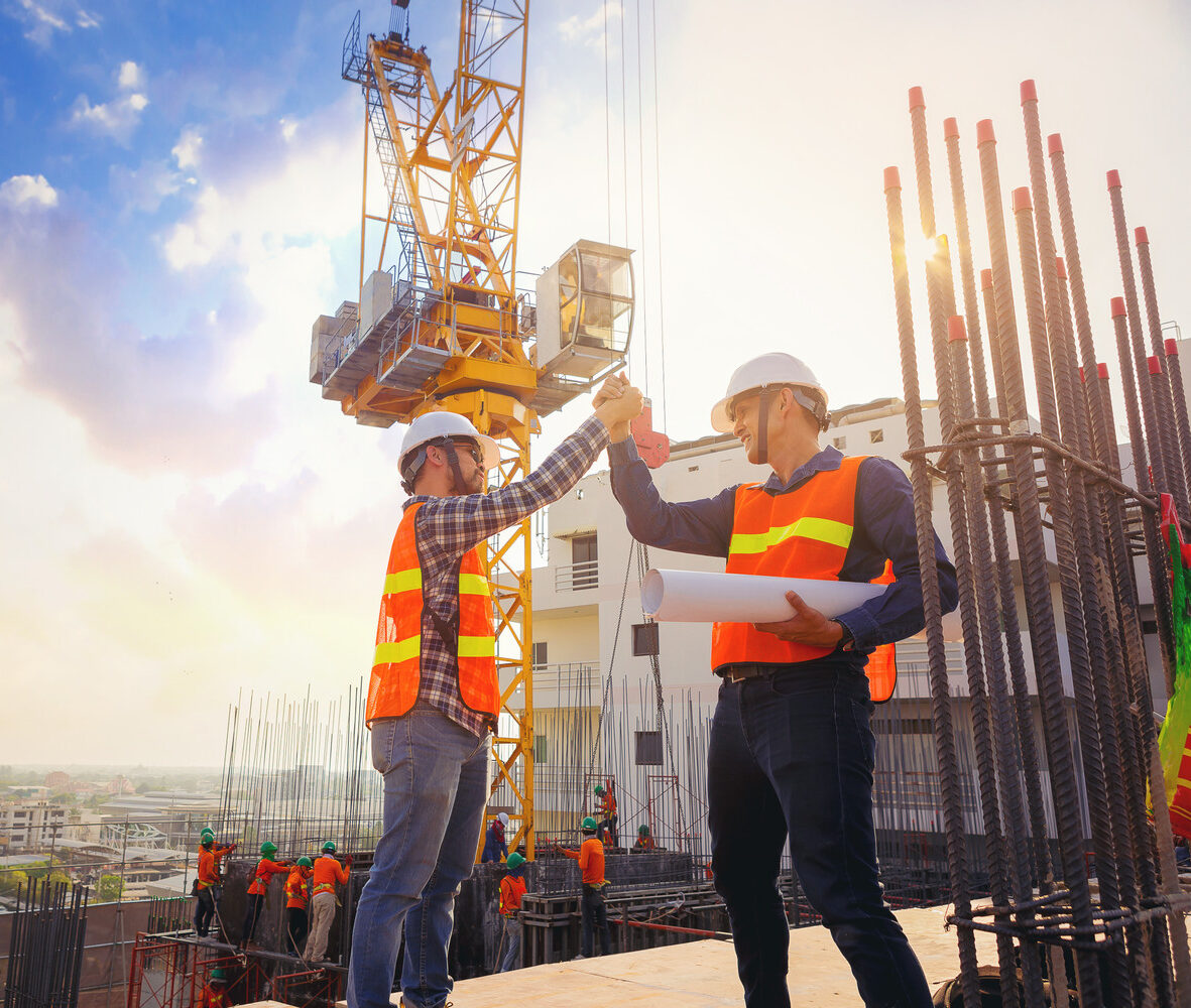Architect,And,Engineer,Construction,Workers,Shaking,Hands,While,Working,At Architect,And,Engineer,Construction,Workers,Shaking,Hands,While,Working,At